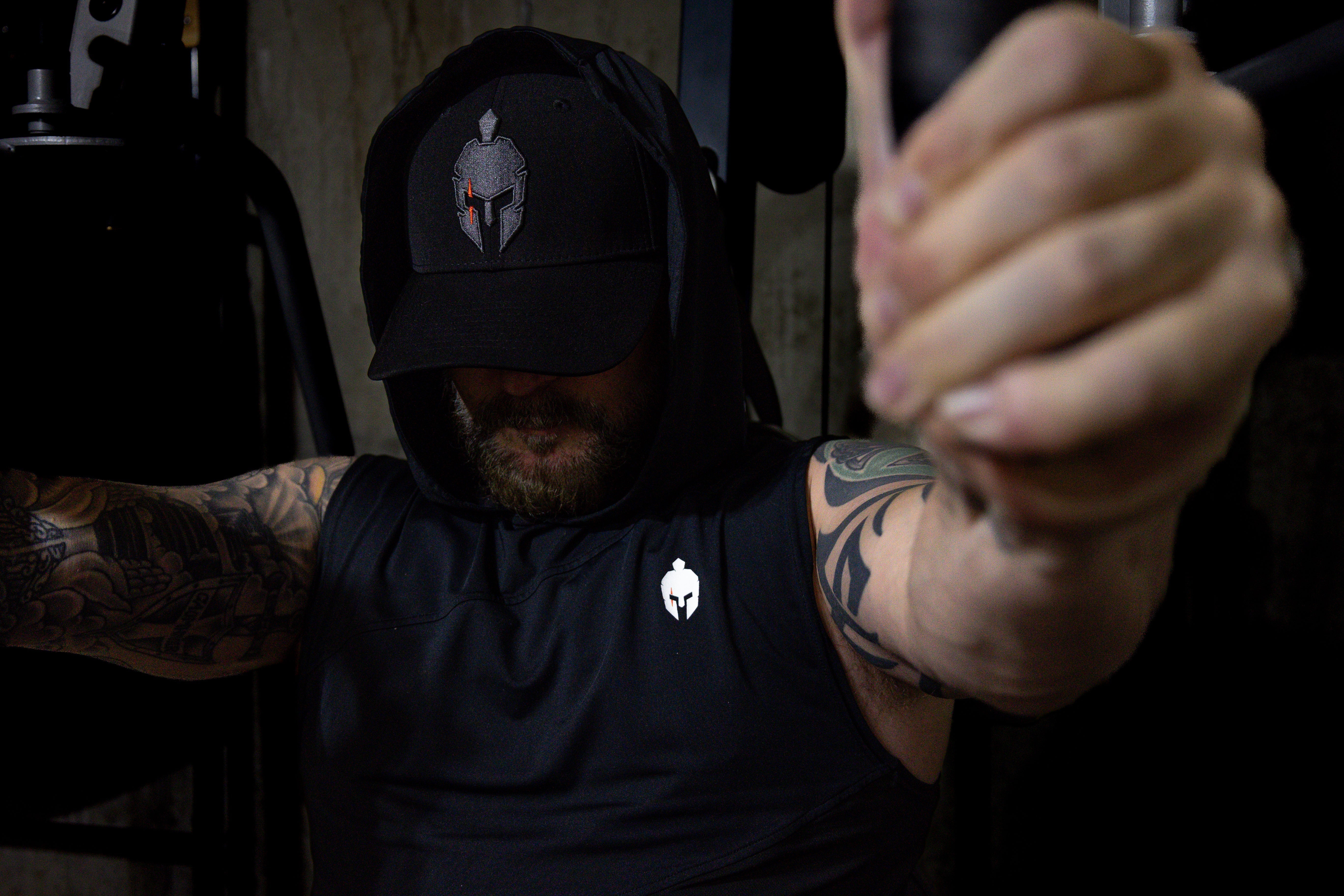 Man wearing Strength of One gym clothes on chest press