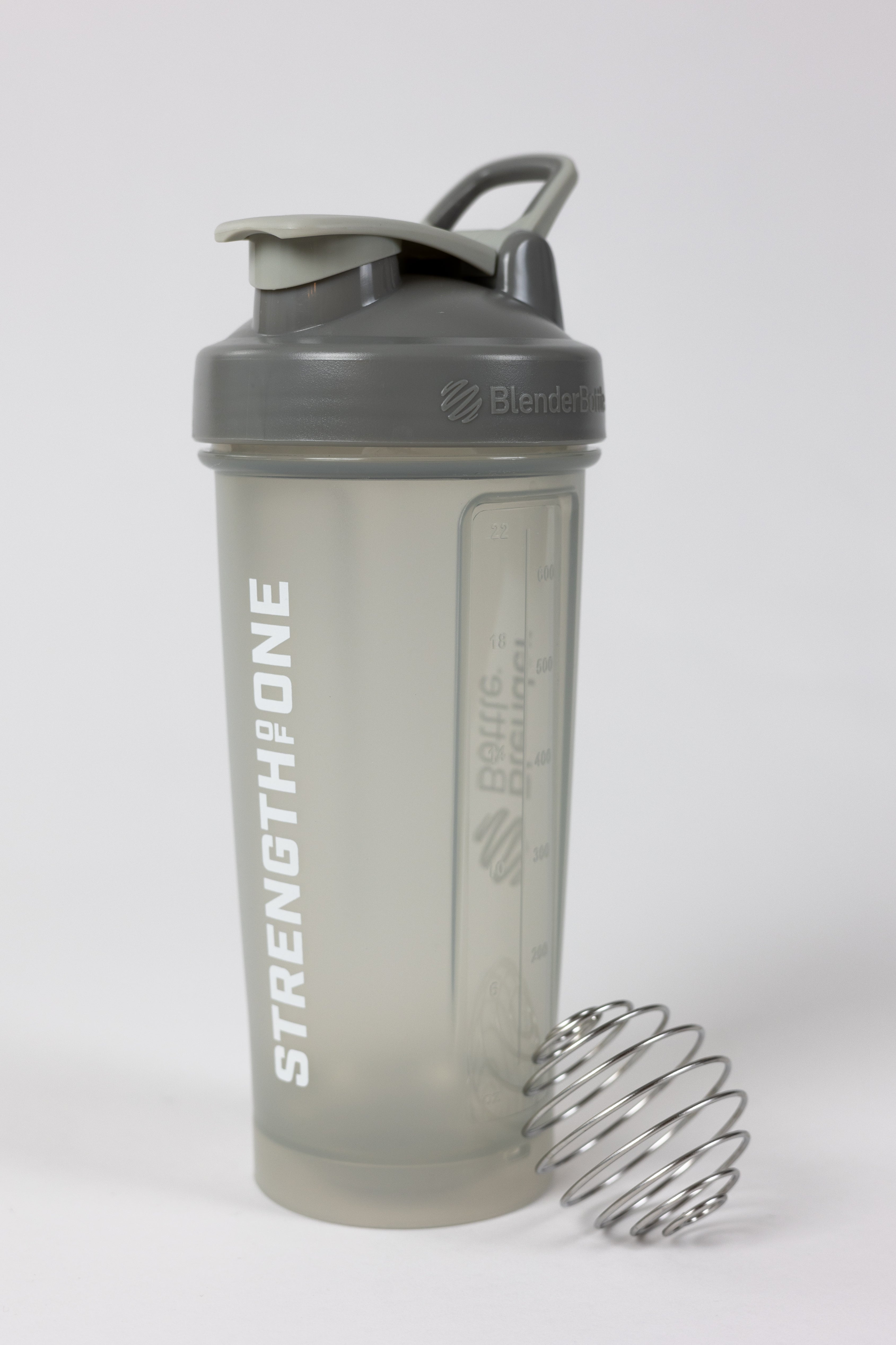 A shaker bottle with the word "Strength Of One" on it, perfect for mixing protein shakes and staying fit.