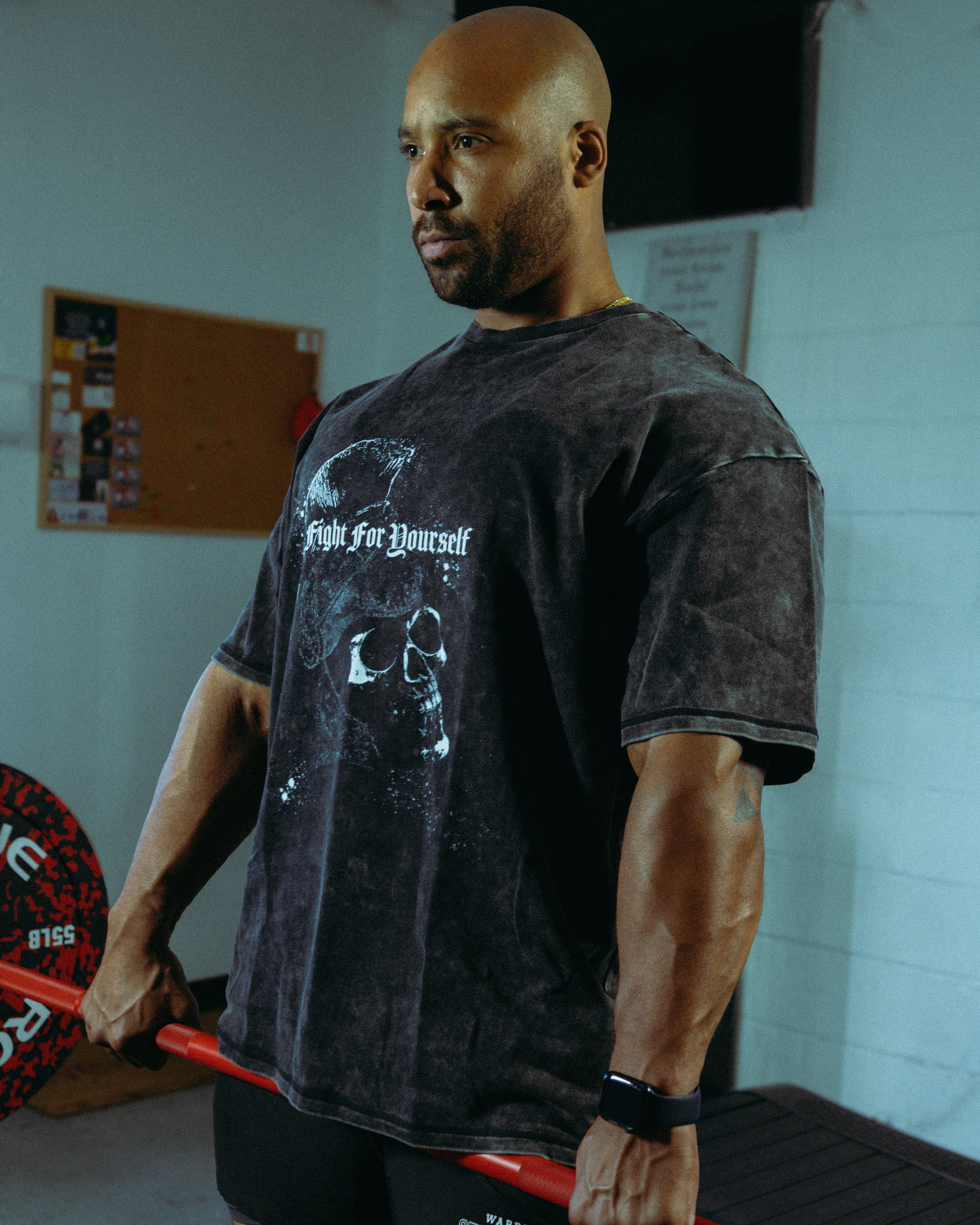 Man wearing Strength of One pump cover performing dead lift in gym