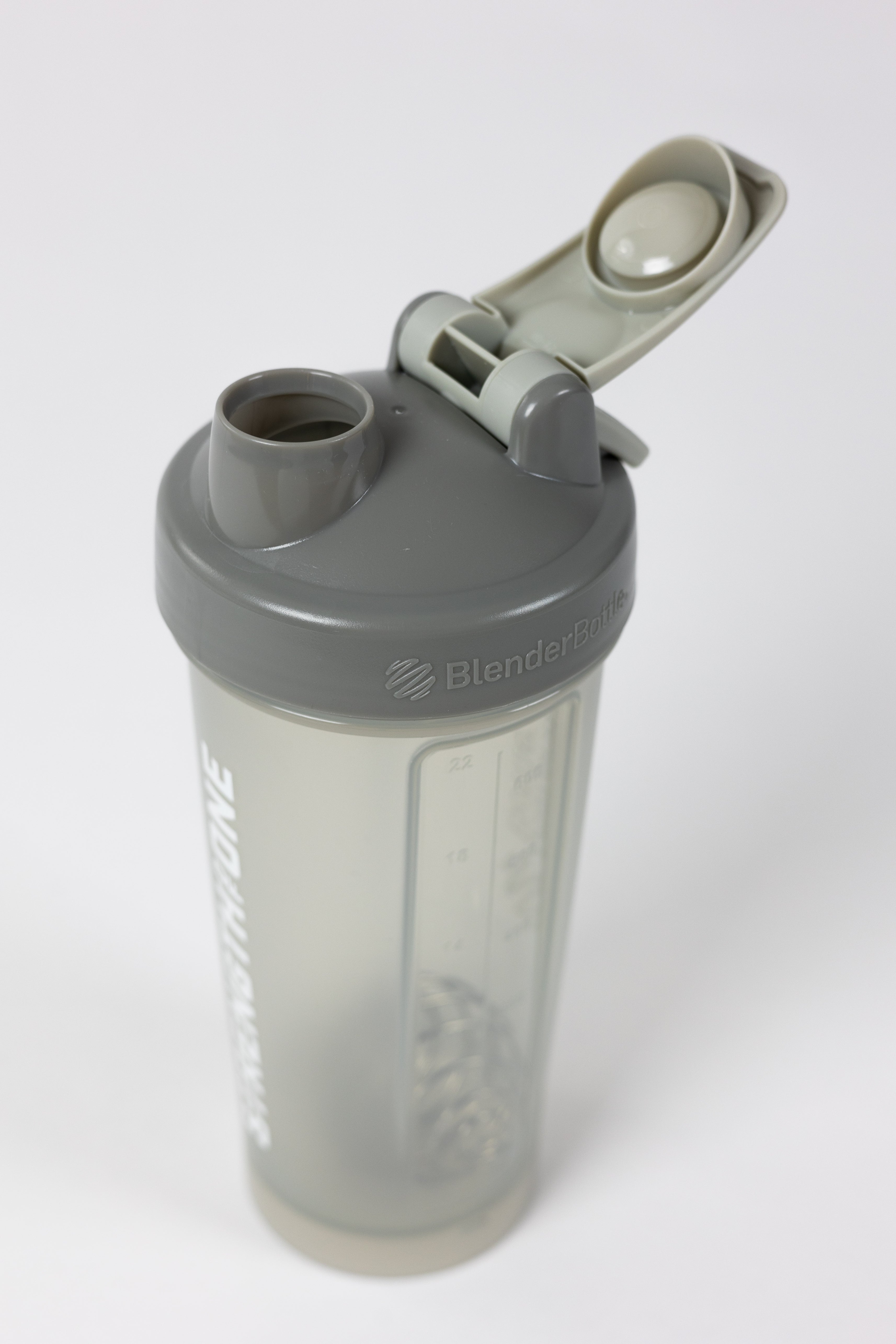 A shaker bottle with the word "Strength Of One" on it, perfect for mixing protein shakes and staying fit.