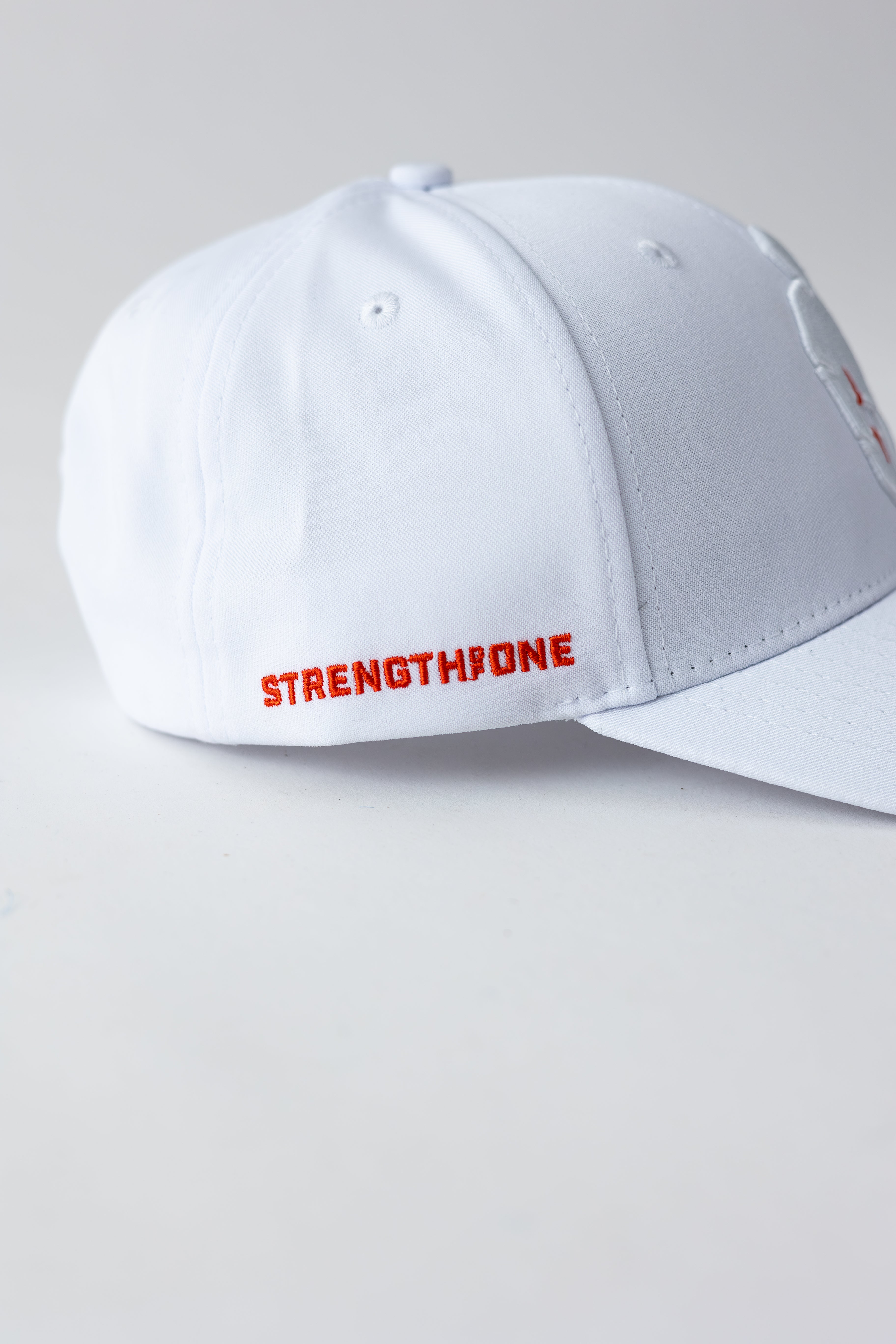 white strength of one hat with embroidered logo