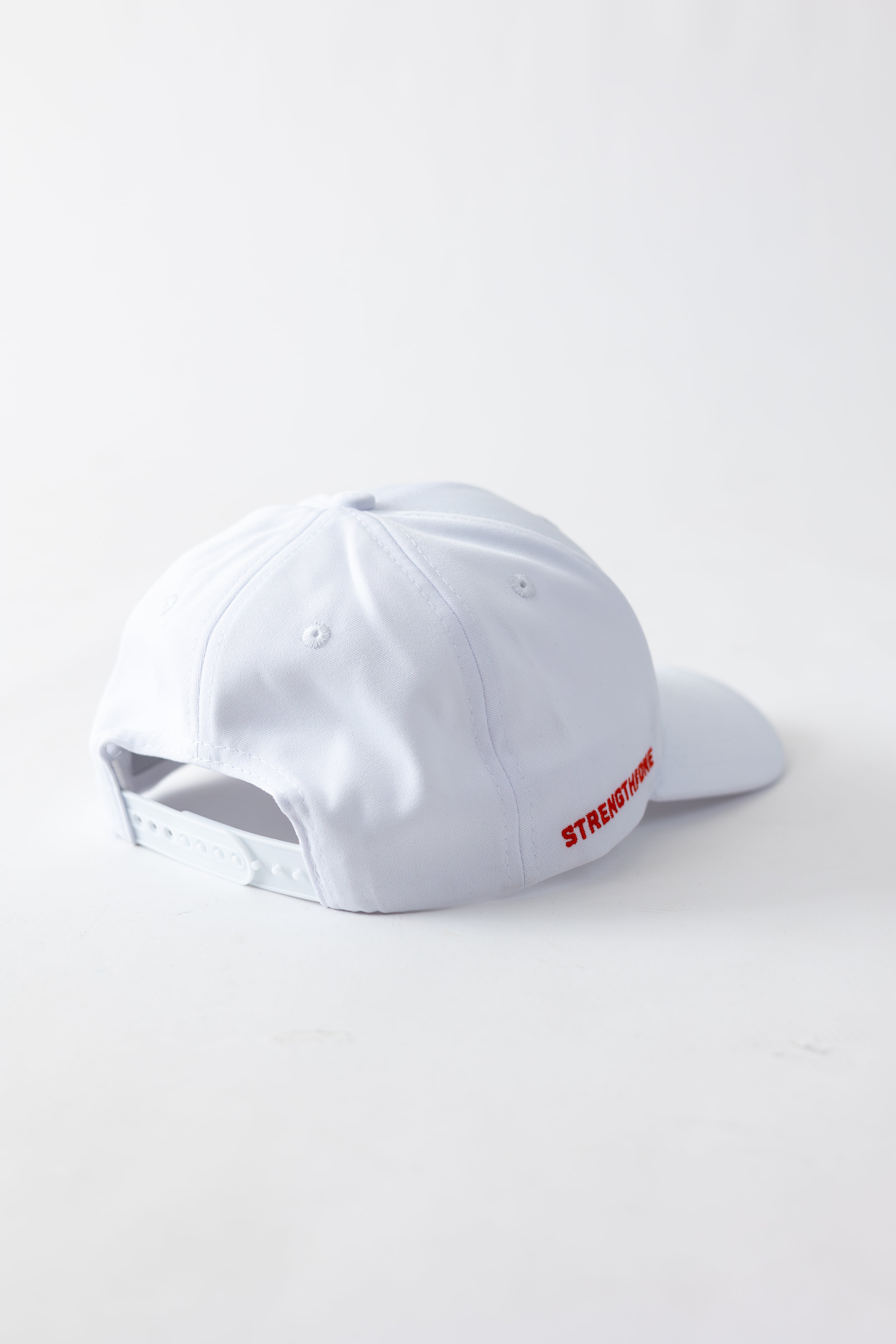 white Strength of One hat with plastic snap closure