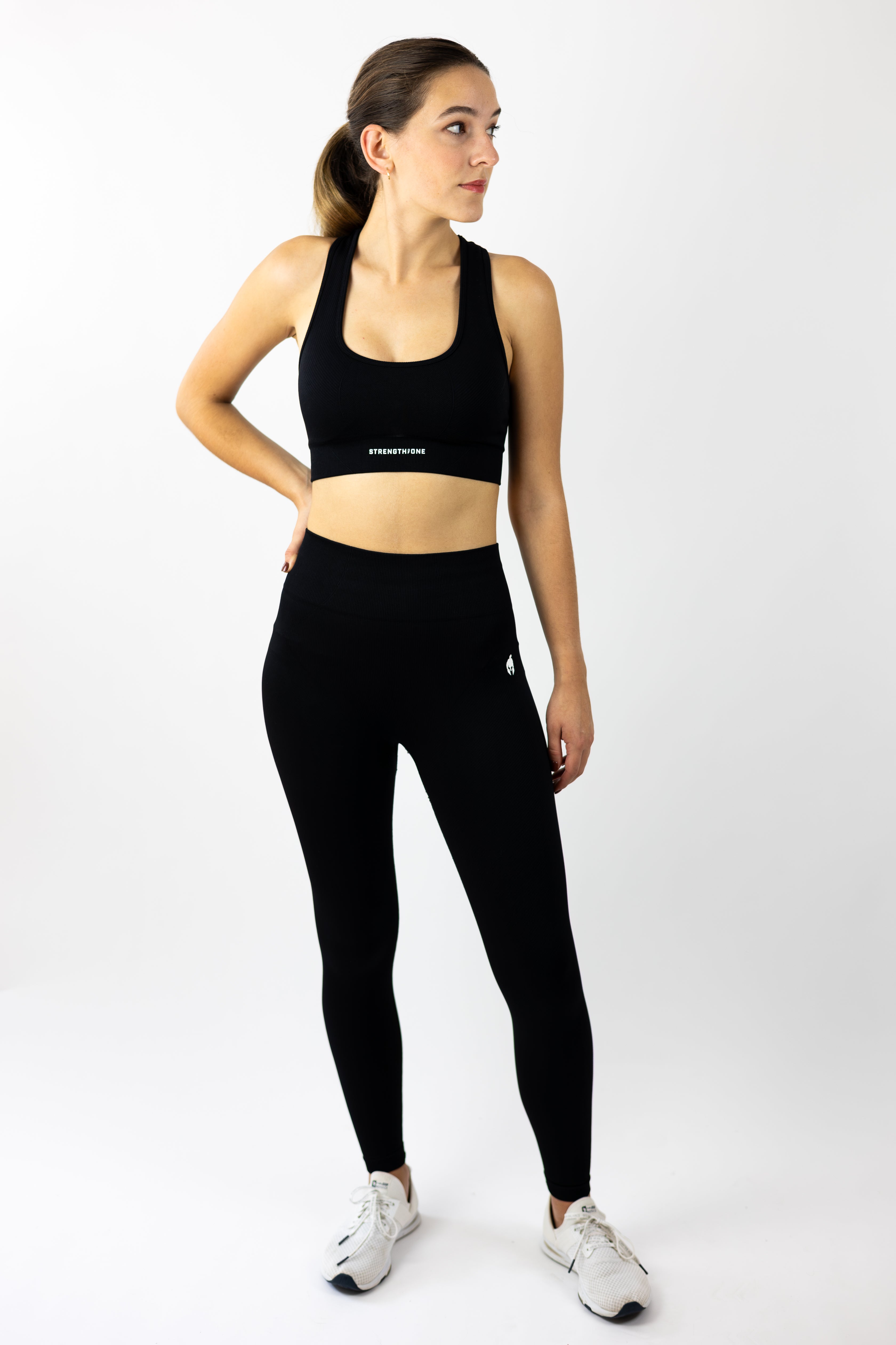 woman modeling Strength of One black yoga pants and sports bra seamless set