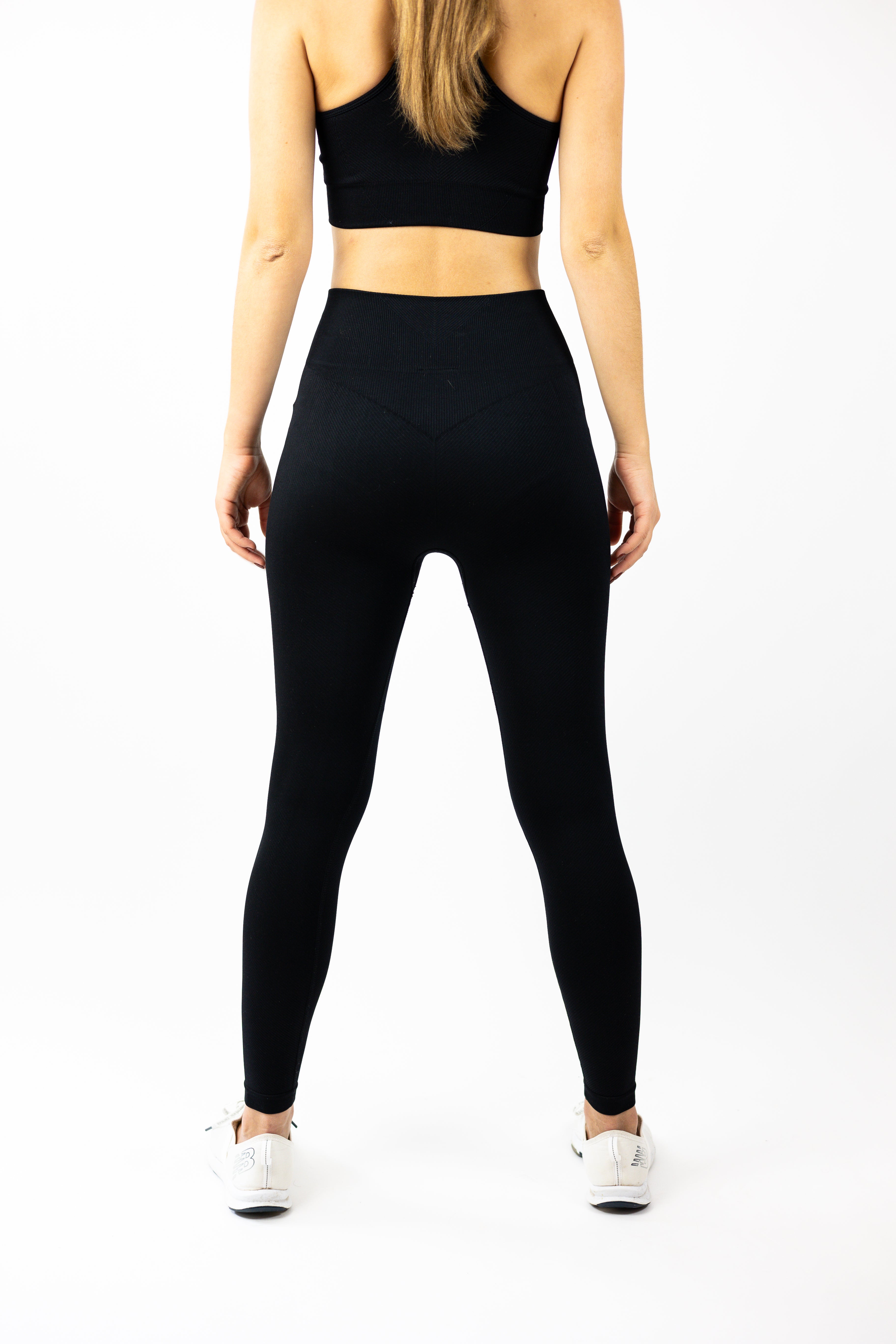 rear view of woman modeling Strength of One black leggings