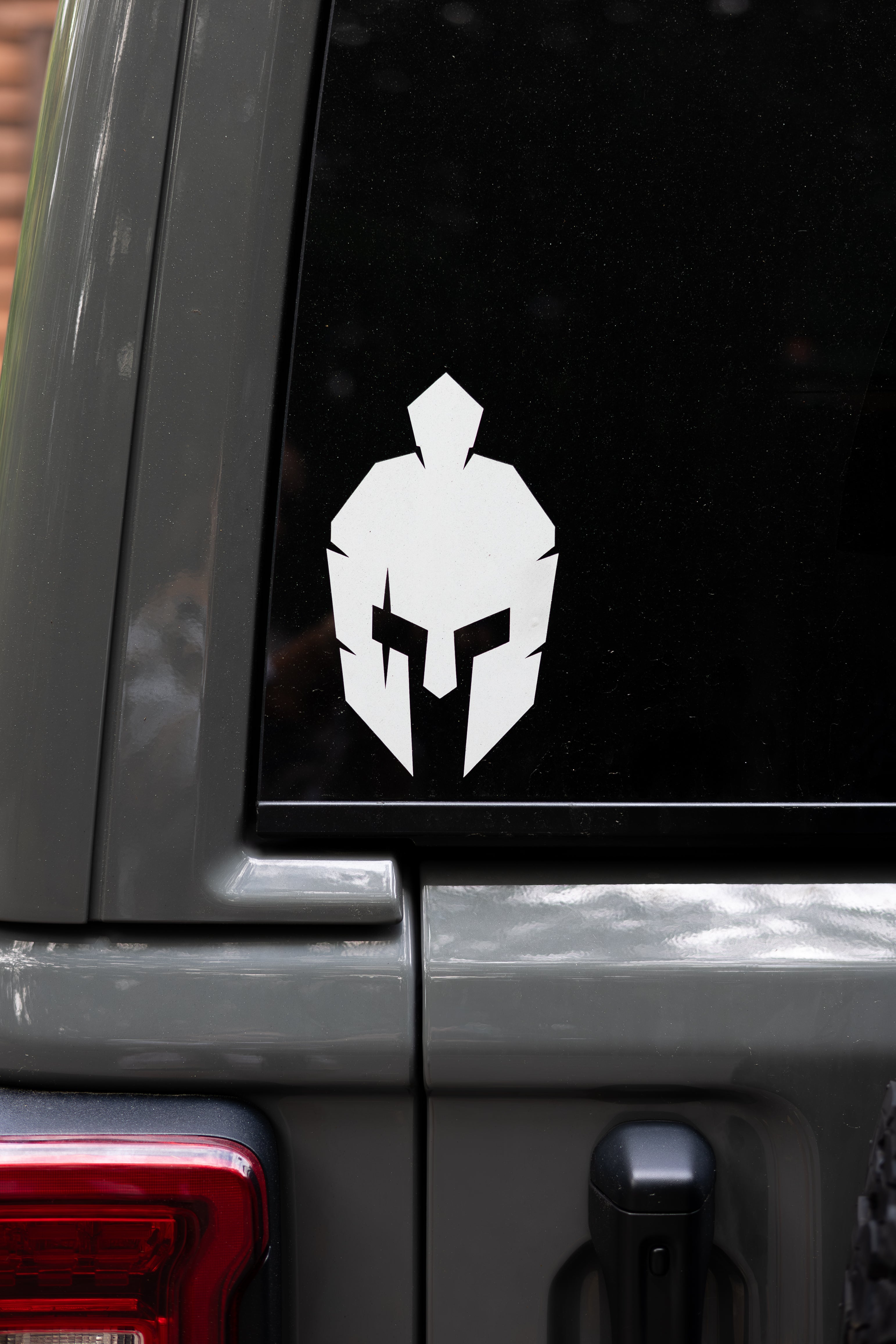 Strength of One spartan warrior helmet sticker on rear glass of vehicle