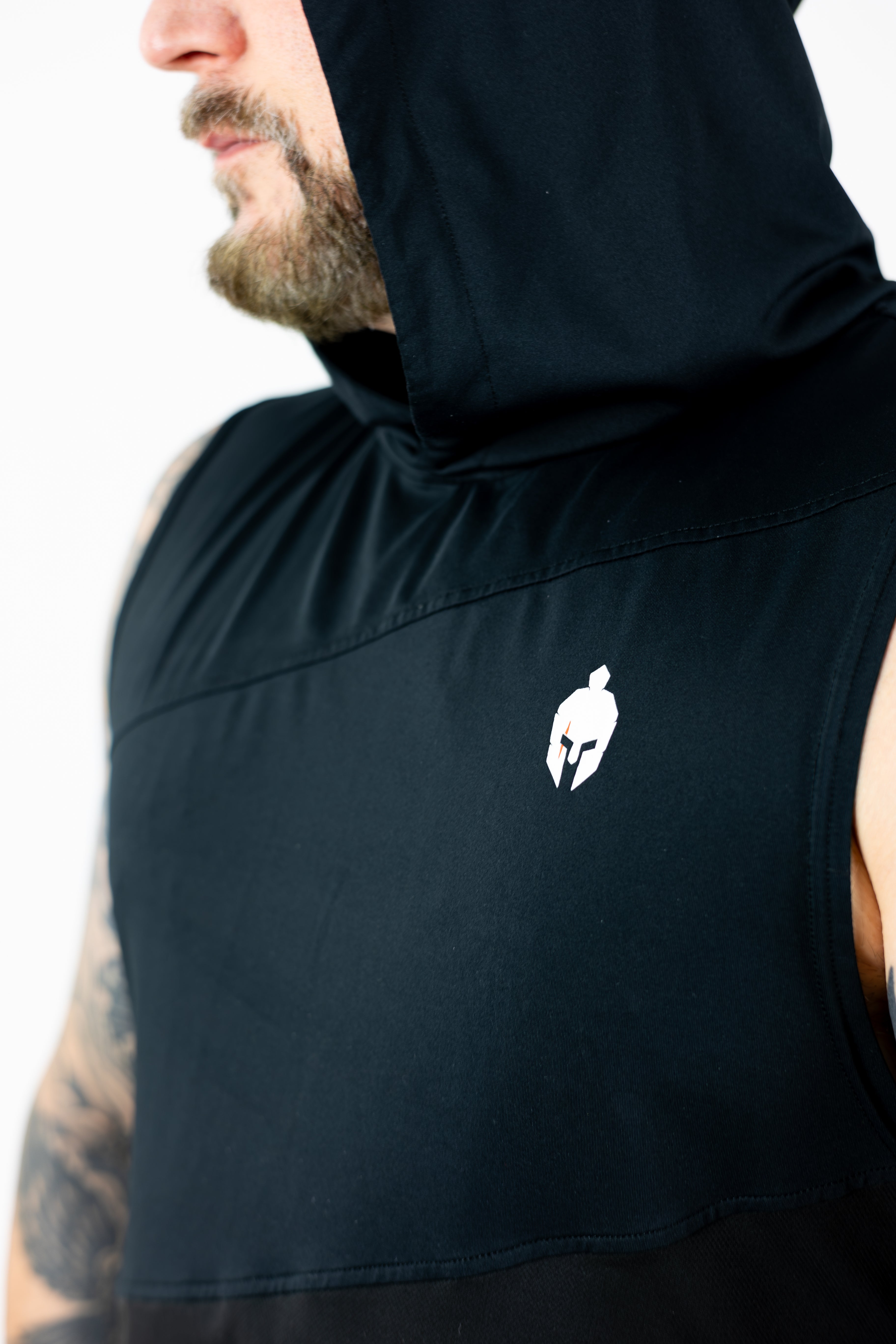 man wearing black hooded strength of one tank top with white helmet warrior logo on right chest