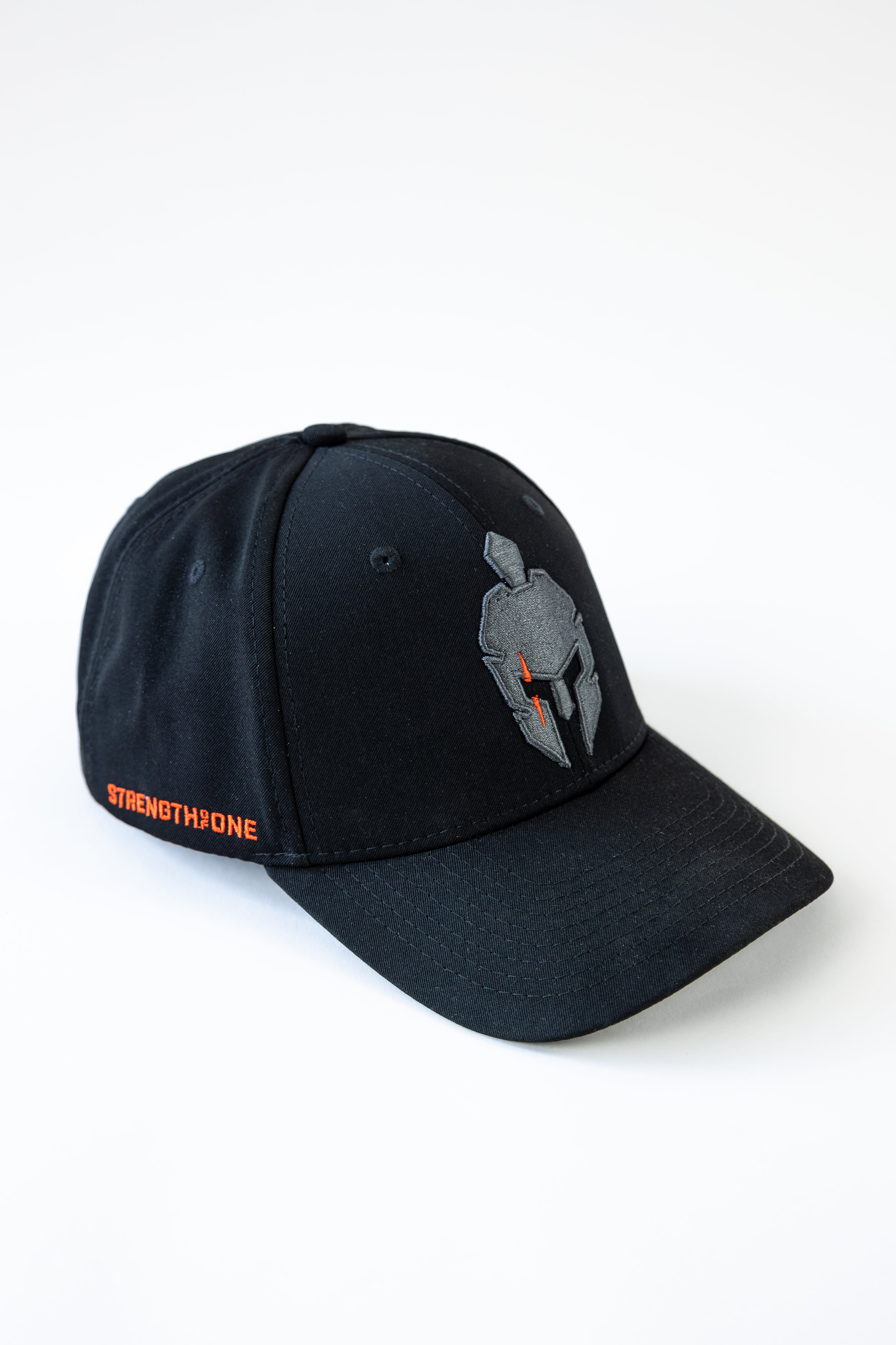 Black Strength of One baseball cap with a gray and orange spartan helmet emblem and Strength of One embroidered on left side